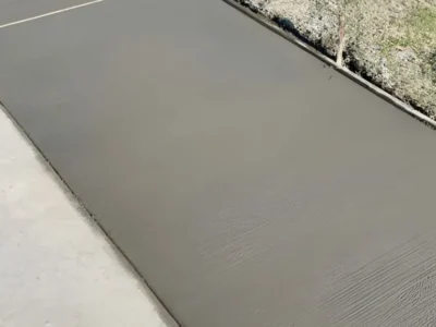Concrete apron connecting driveway to public sidewalk at street