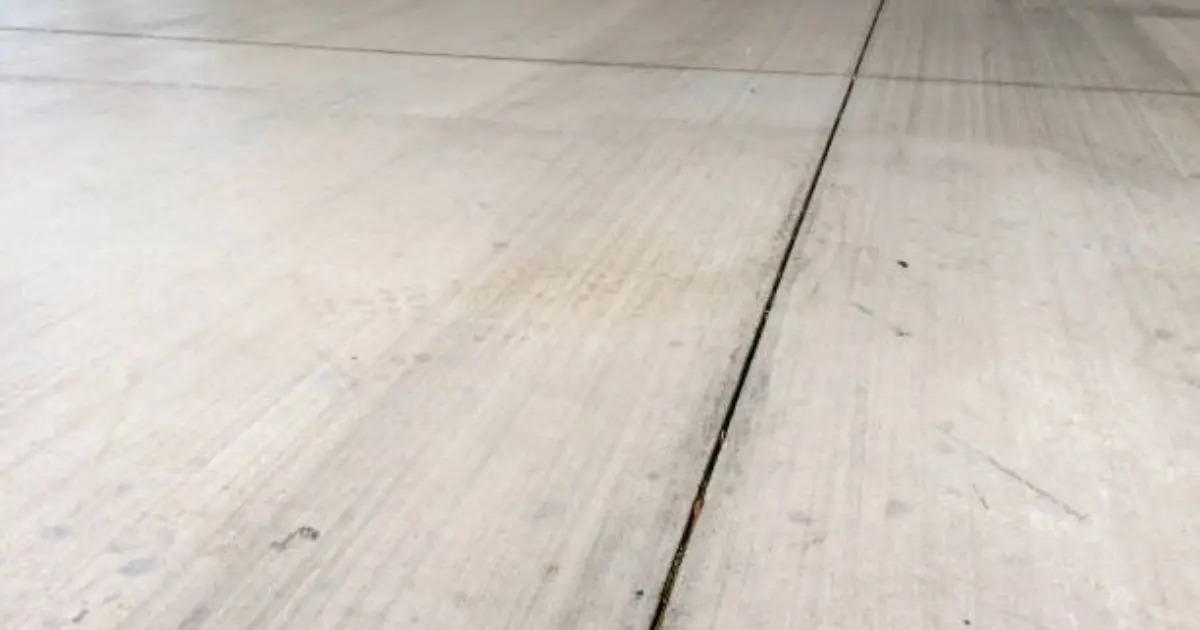 Concrete garage floor slab with control joints and smooth finish