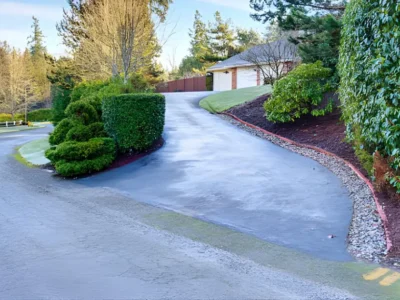 Curved concrete driveway with decorative border at home entrance