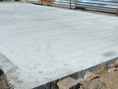Monolithic concrete slab foundation with turned-down edges for home