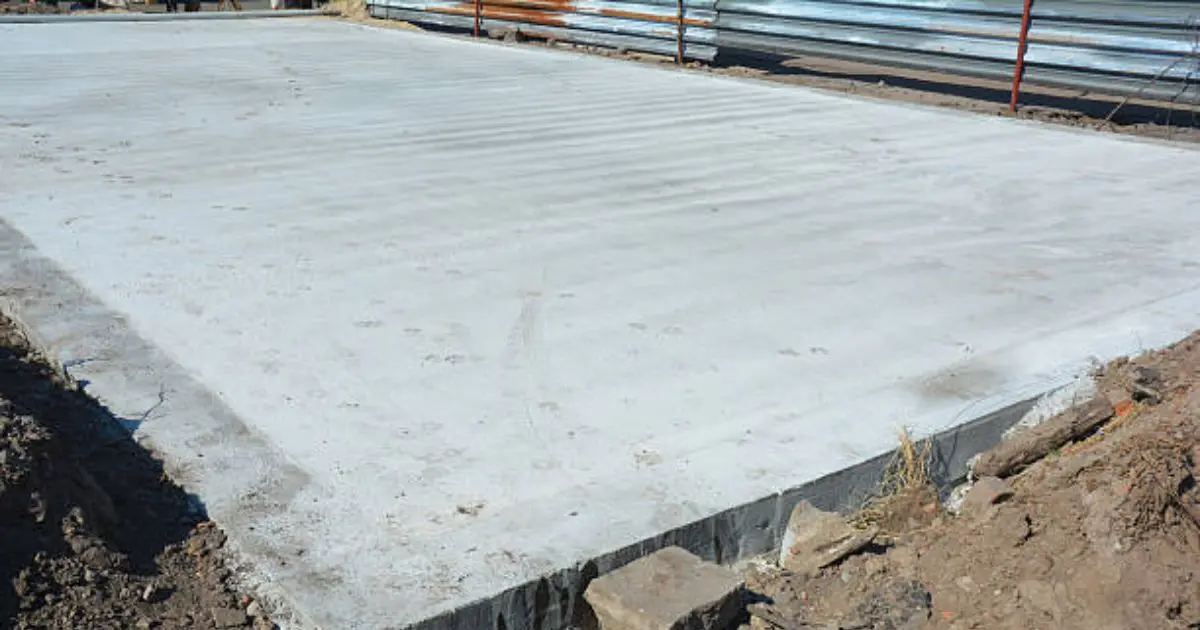 Monolithic concrete slab foundation with turned-down edges for home
