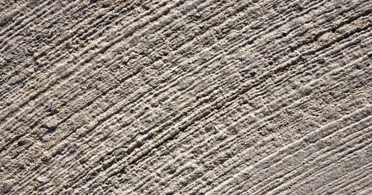 Rough brushed concrete surface texture with visible aggregate detail