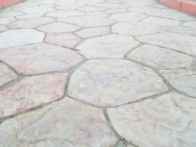 Stamped concrete walkway with flagstone pattern leading to front door