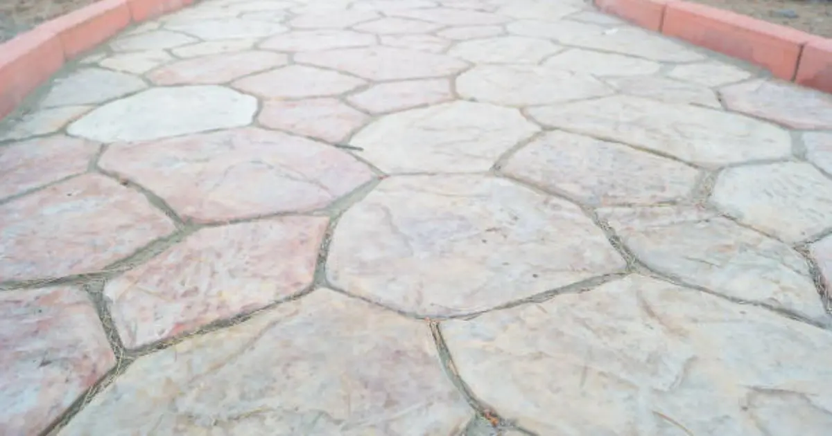 Stamped concrete walkway with flagstone pattern leading to front door